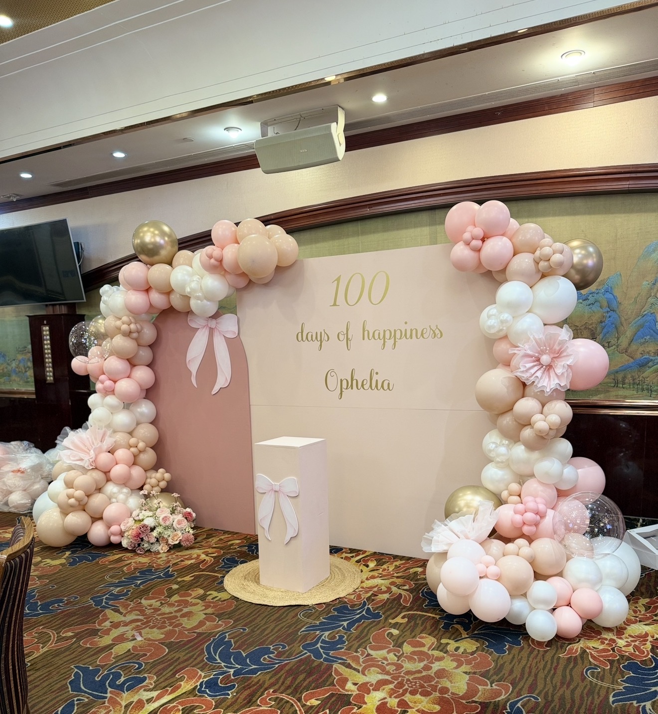 Blush balloon backdrop for a 100 days celebration